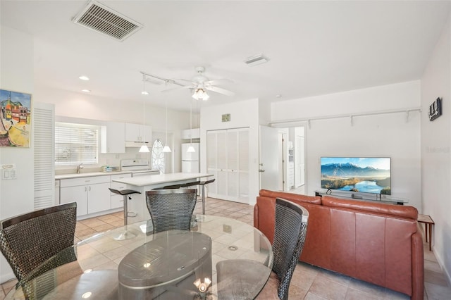 dining space featuring light tile patterned flooring and ceiling fan