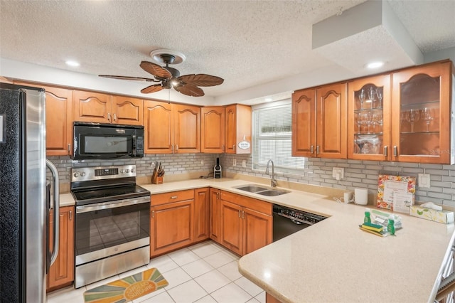 kitchen featuring ceiling fan, light tile patterned flooring, sink, a textured ceiling, and black appliances