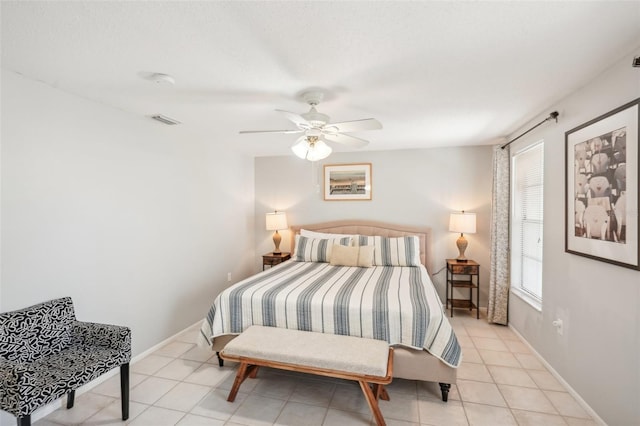 tiled bedroom featuring ceiling fan