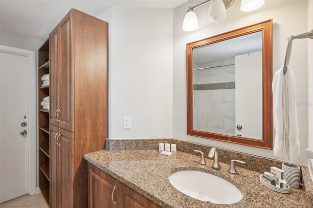 bathroom featuring vanity, a shower, and tile patterned floors