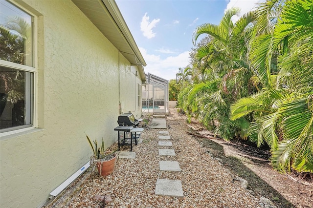 view of yard with a patio area and a lanai