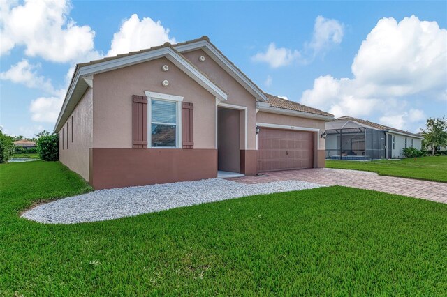 view of front of house with a garage and a front lawn