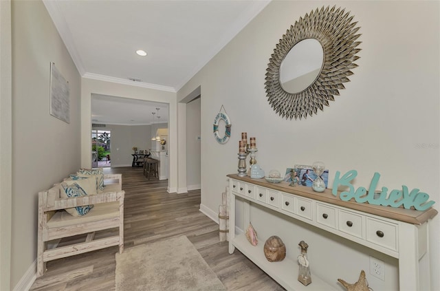 hallway featuring ornamental molding and hardwood / wood-style floors