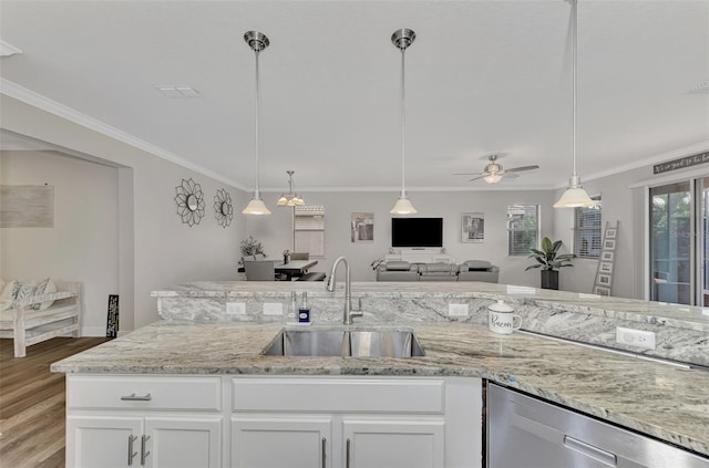 kitchen featuring decorative light fixtures, light stone countertops, sink, and white cabinets