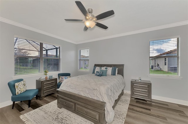 bedroom featuring ornamental molding, multiple windows, dark hardwood / wood-style floors, and ceiling fan