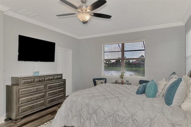 bedroom with ceiling fan, hardwood / wood-style flooring, and ornamental molding