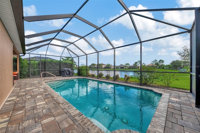 view of swimming pool featuring a patio area, a water view, and a lanai