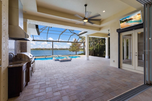 view of patio / terrace featuring french doors, an outdoor kitchen, a lanai, and sink