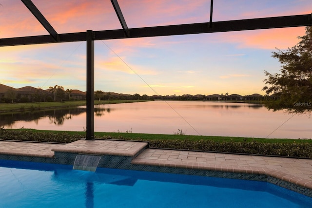 pool at dusk with glass enclosure and a water view