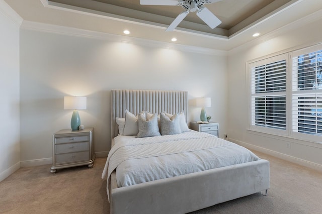 carpeted bedroom featuring a tray ceiling, ceiling fan, and ornamental molding