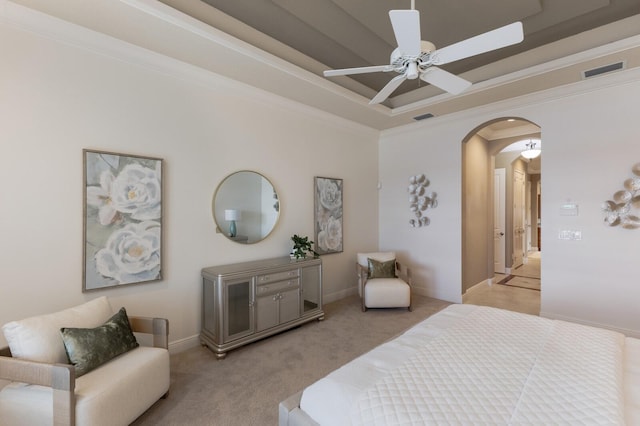 carpeted bedroom featuring ceiling fan and crown molding