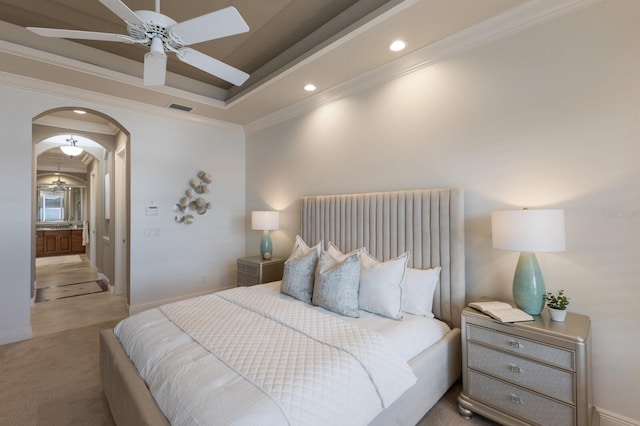 carpeted bedroom featuring ceiling fan, crown molding, and a tray ceiling