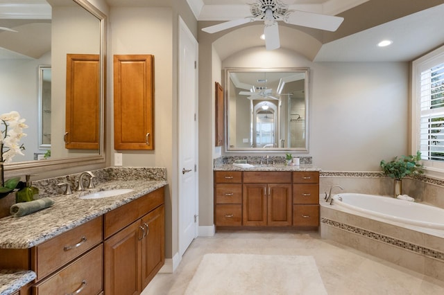 bathroom featuring vanity, ceiling fan, lofted ceiling, and tiled bath