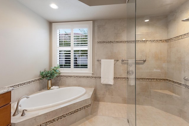 bathroom with vanity and separate shower and tub