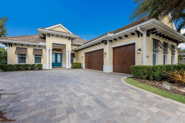 view of front of house with french doors and a garage