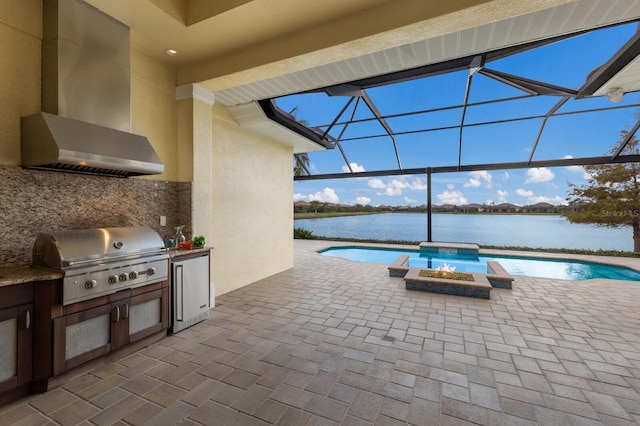 view of pool featuring a hot tub, a water view, area for grilling, and a patio area