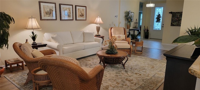 living area featuring baseboards and wood finished floors