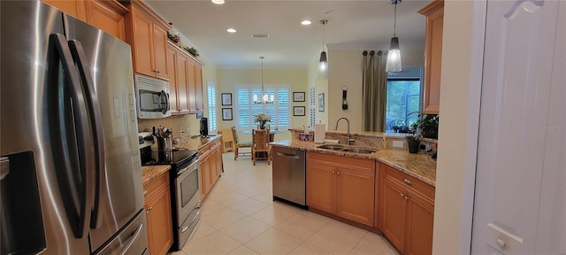 kitchen with an inviting chandelier, a peninsula, light tile patterned flooring, a sink, and appliances with stainless steel finishes