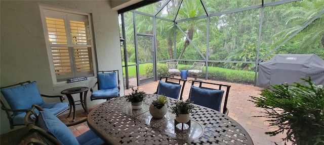 view of patio / terrace with a lanai and area for grilling