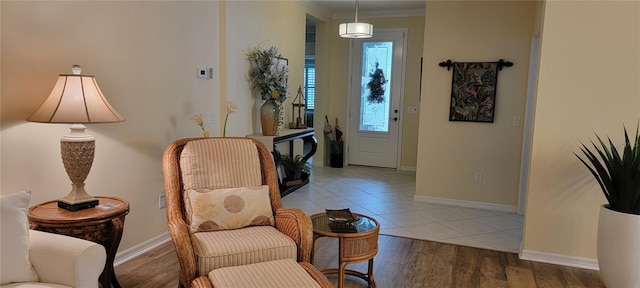 foyer with wood-type flooring and crown molding