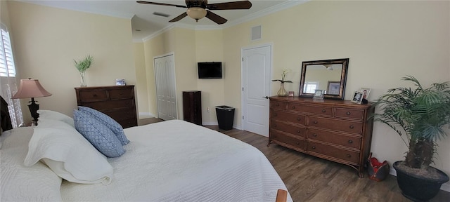 bedroom with a closet, crown molding, ceiling fan, and dark wood-type flooring