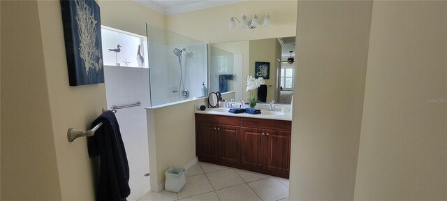 bathroom with double vanity, tile patterned floors, crown molding, and walk in shower