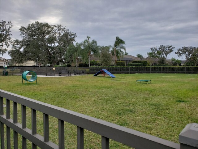 surrounding community featuring fence and a yard