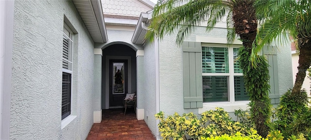 view of exterior entry with stucco siding