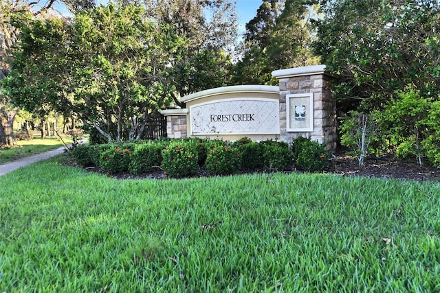 community / neighborhood sign with a lawn