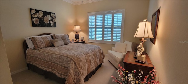 bedroom featuring baseboards, ornamental molding, and carpet flooring