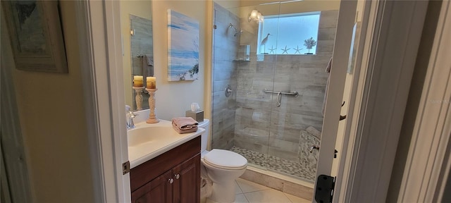 bathroom with tile patterned flooring, vanity, an enclosed shower, and toilet