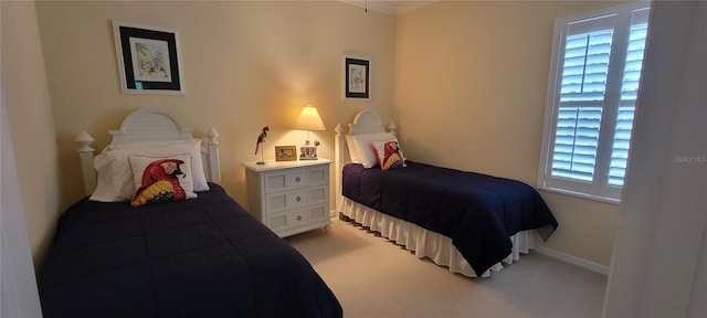 bedroom featuring baseboards, ornamental molding, and carpet flooring
