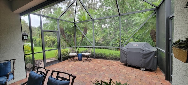 view of patio / terrace with a lanai and a grill