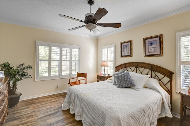 bedroom with a textured ceiling, ceiling fan, dark hardwood / wood-style floors, and crown molding