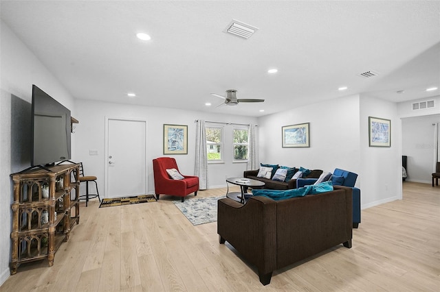 living room featuring light hardwood / wood-style floors and ceiling fan