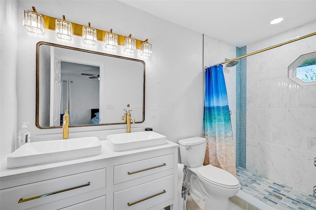 bathroom featuring vanity, toilet, curtained shower, and tile patterned flooring