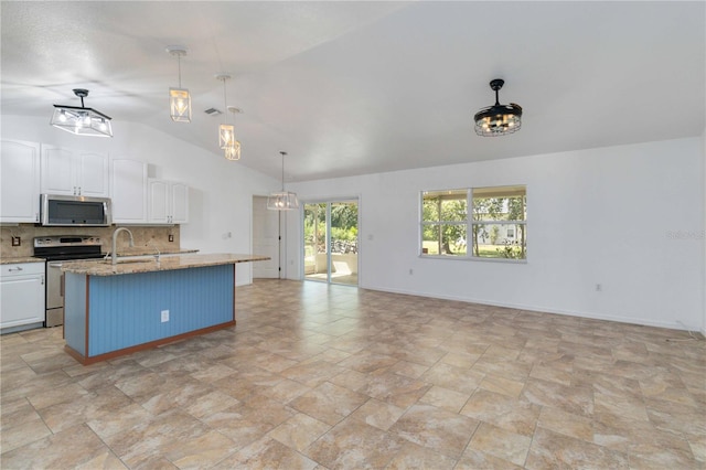 kitchen featuring a center island with sink, appliances with stainless steel finishes, backsplash, and white cabinetry