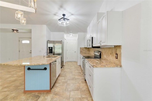 kitchen featuring pendant lighting, stainless steel appliances, white cabinetry, and light stone counters