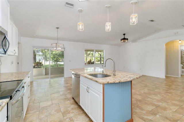 kitchen with lofted ceiling, sink, a center island with sink, white cabinetry, and stainless steel appliances