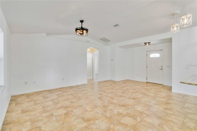 spare room with lofted ceiling