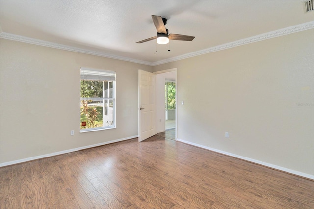 empty room featuring ornamental molding, wood-type flooring, and ceiling fan