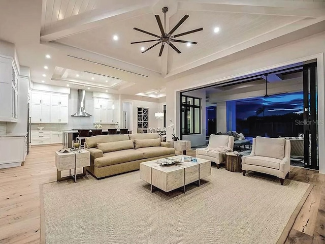 living room with light hardwood / wood-style flooring, lofted ceiling with beams, and ceiling fan