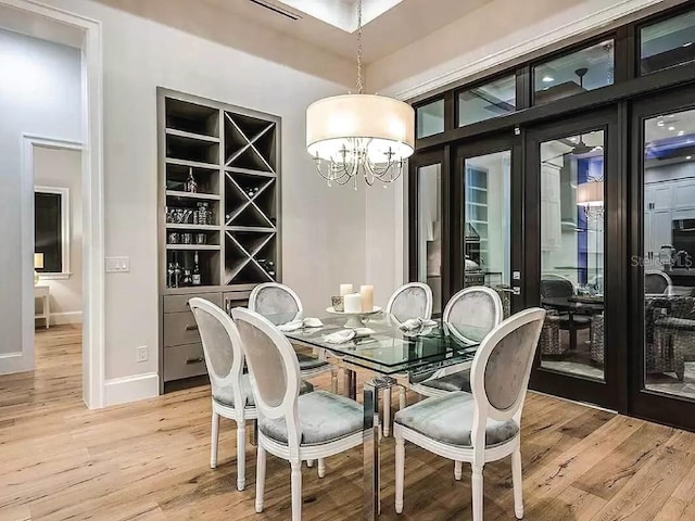 dining area featuring hardwood / wood-style floors and a chandelier