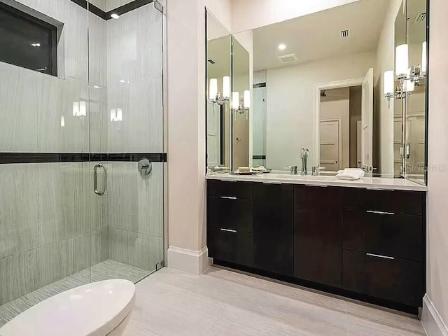 bathroom with vanity, tile patterned floors, and a shower with door