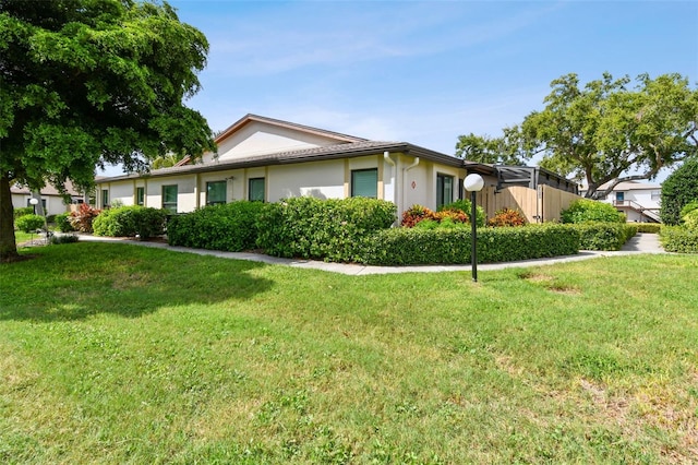 ranch-style home with a front lawn