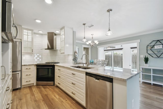 kitchen with sink, light hardwood / wood-style flooring, wall chimney range hood, and stainless steel appliances