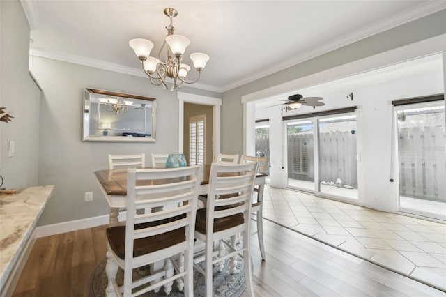 dining room featuring light hardwood / wood-style floors, ornamental molding, and ceiling fan with notable chandelier