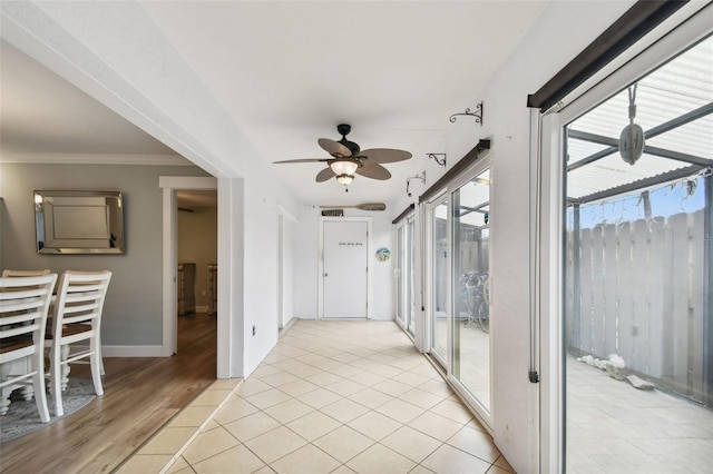 hallway with ornamental molding and light wood-type flooring