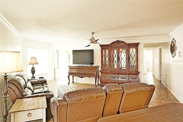 living room with crown molding and ceiling fan