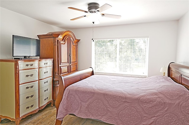 bedroom with ceiling fan and hardwood / wood-style flooring